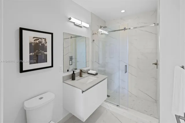 a bathroom with a granite countertop sink a mirror a shower and a bathtub