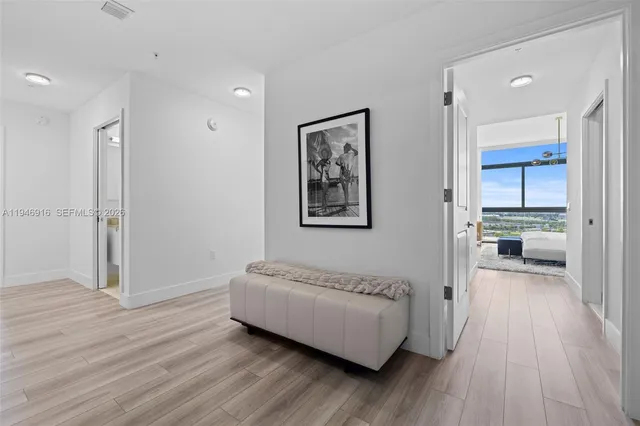 a bedroom with a large bed and a chandelier