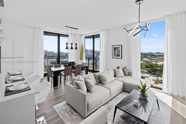 a kitchen with stainless steel appliances granite countertop a refrigerator a stove a sink dishwasher and white cabinets with wooden floor