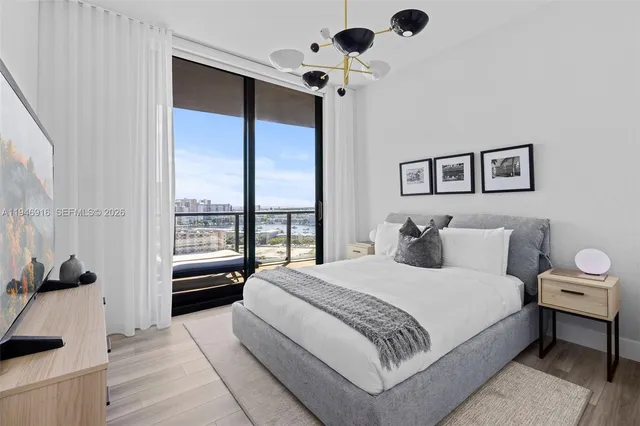 a room with furniture a flat screen tv and a large window