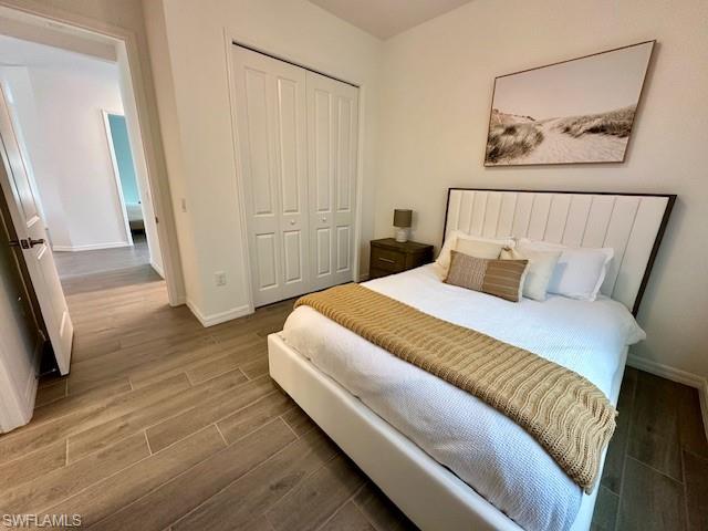 5856 Sunningdale St Avenue Immokalee, FL 34142 - Photo 19 of 44 a bedroom with a bed and a painting on the wall