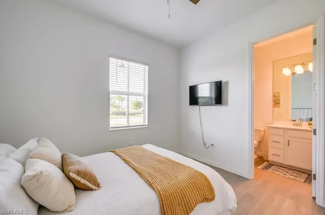 a bedroom with a bed and a television