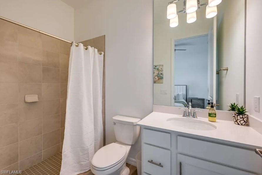 5856 Sunningdale St Avenue Immokalee, FL 34142 - Photo 21 of 44 a bathroom with a sink a mirror a toilet and shower