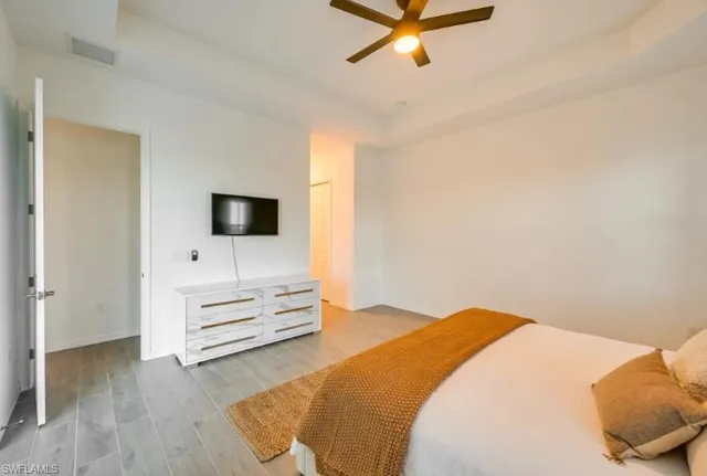 a bedroom with a bed and a flat screen tv