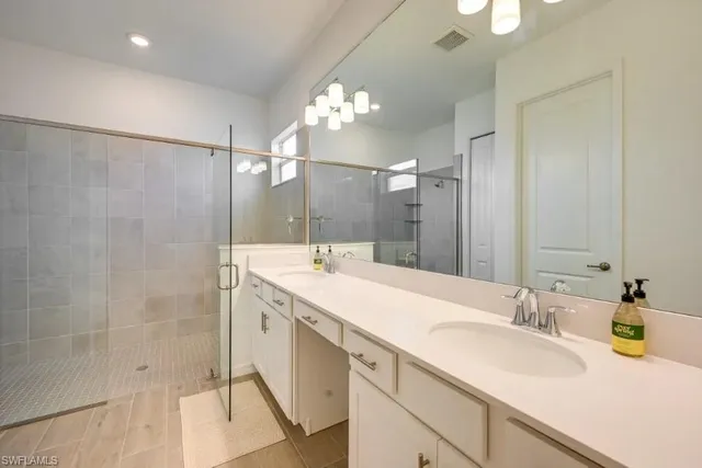 a bathroom with a sink double vanity and a mirror