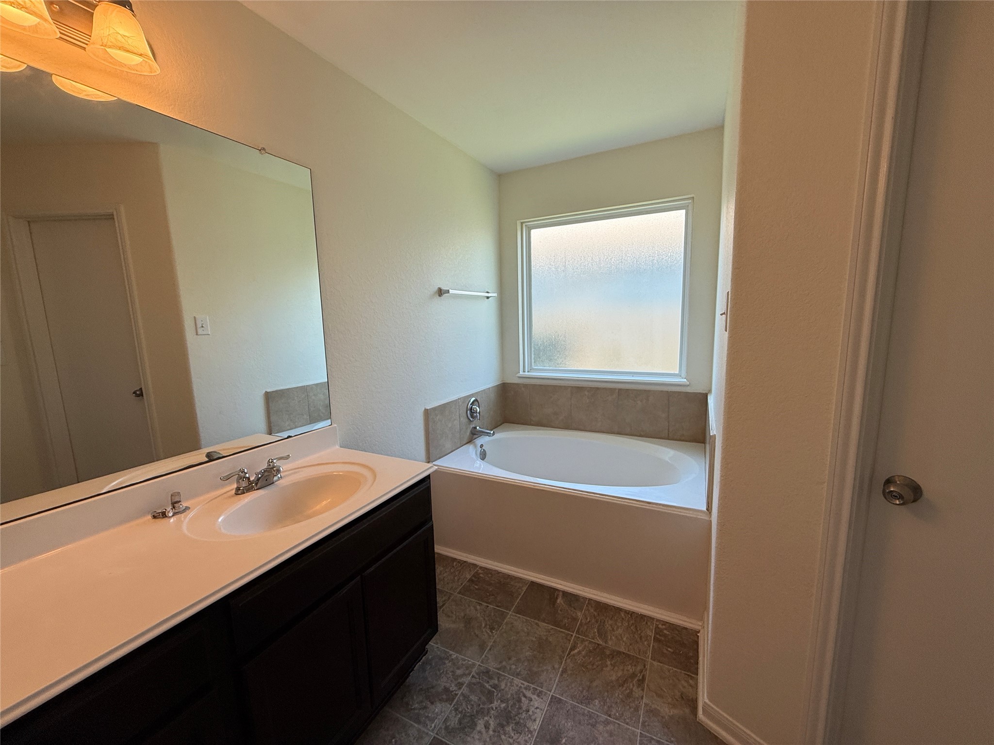 3306 View Valley Trail Katy, TX 77493 - Photo 13 of 19 a bathroom with a tub sink and mirror