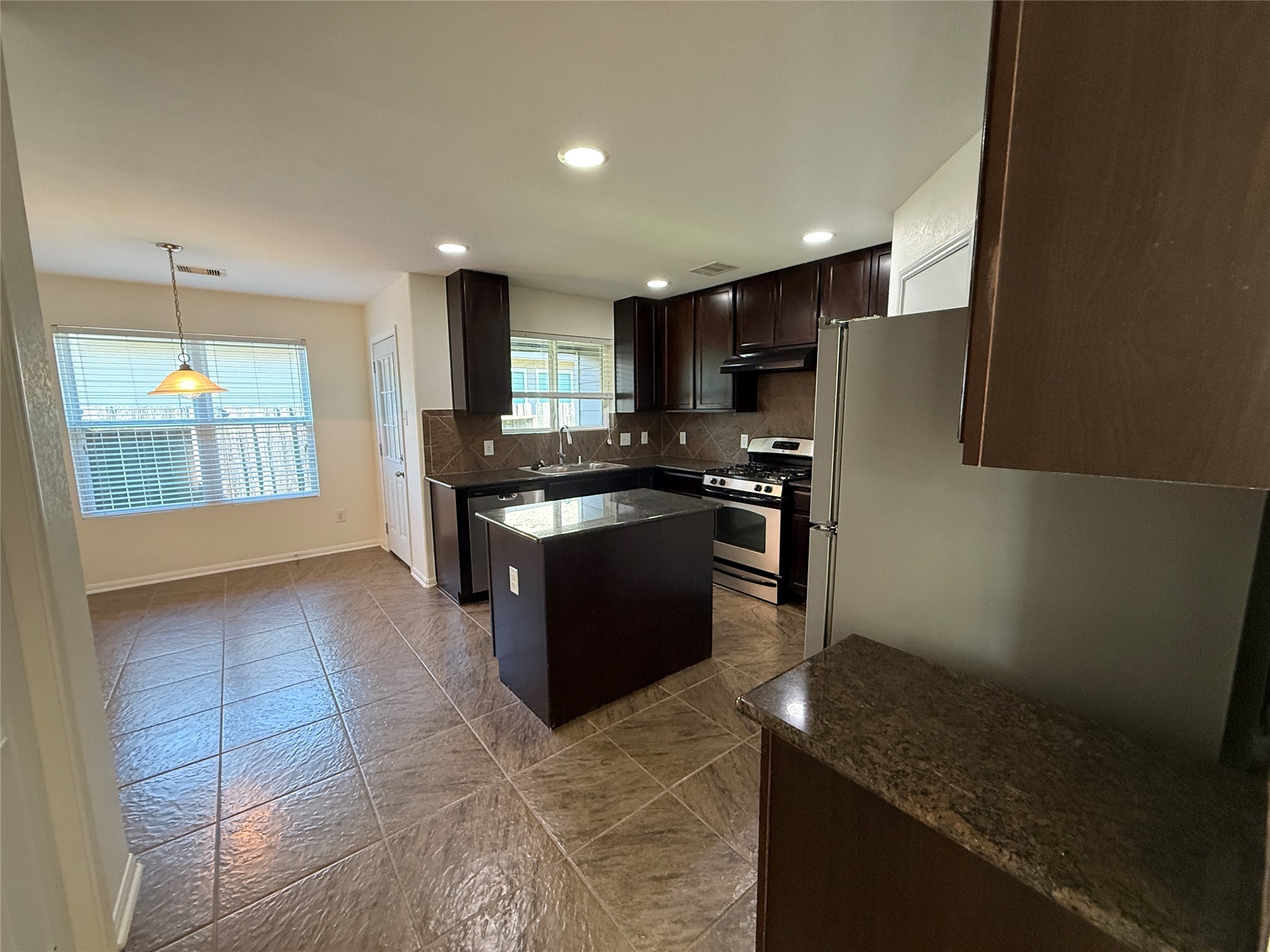 3306 View Valley Trail Katy, TX 77493 - Photo 7 of 19 a kitchen with stainless steel appliances granite countertop a stove a sink a refrigerator and a microwave