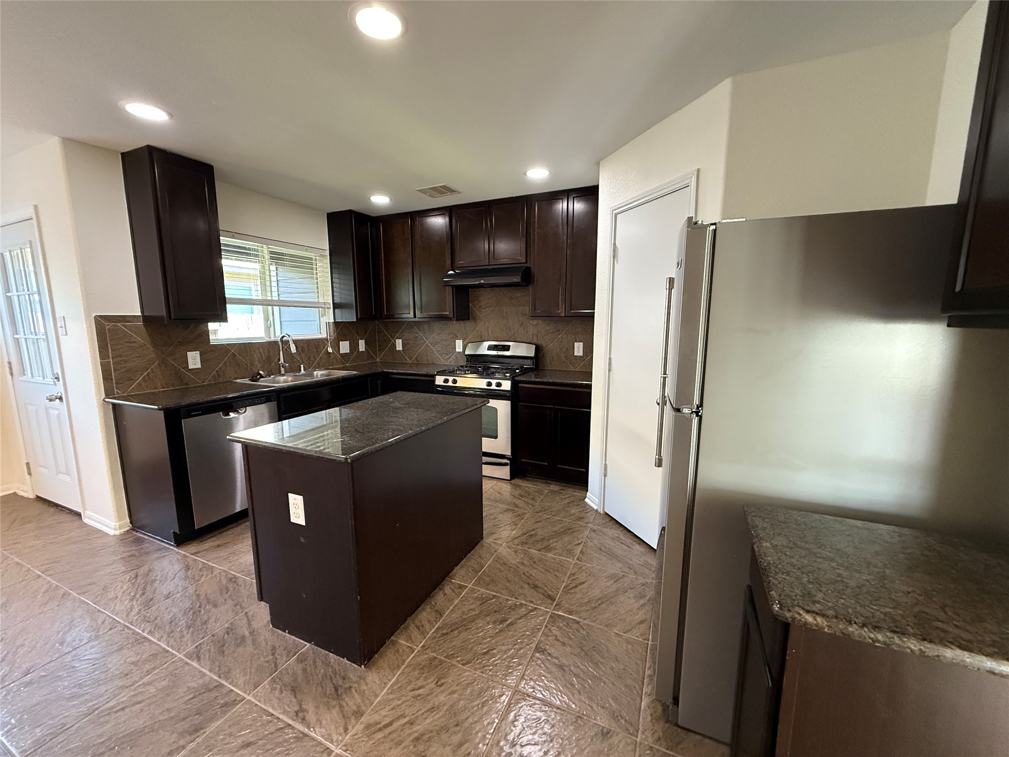 3306 View Valley Trail Katy, TX 77493 - Photo 8 of 19 a kitchen with stainless steel appliances granite countertop a stove a refrigerator a sink and dishwasher