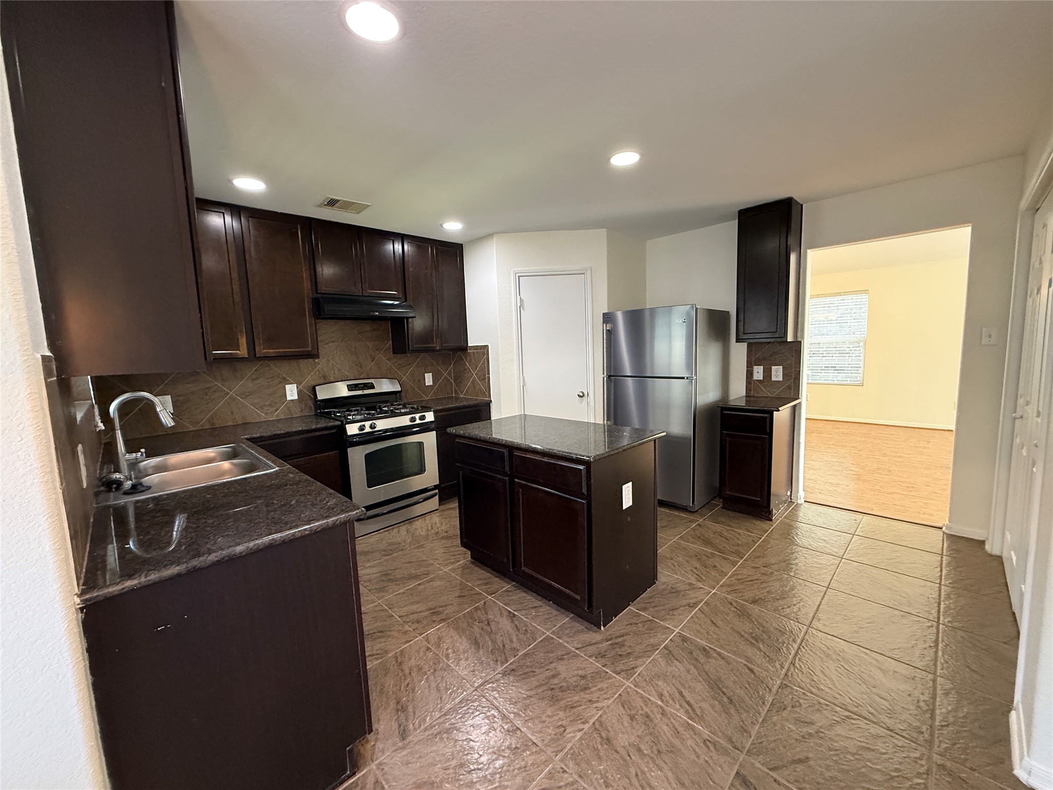 3306 View Valley Trail Katy, TX 77493 - Photo 10 of 19 a kitchen with stainless steel appliances granite countertop a stove a sink and a refrigerator