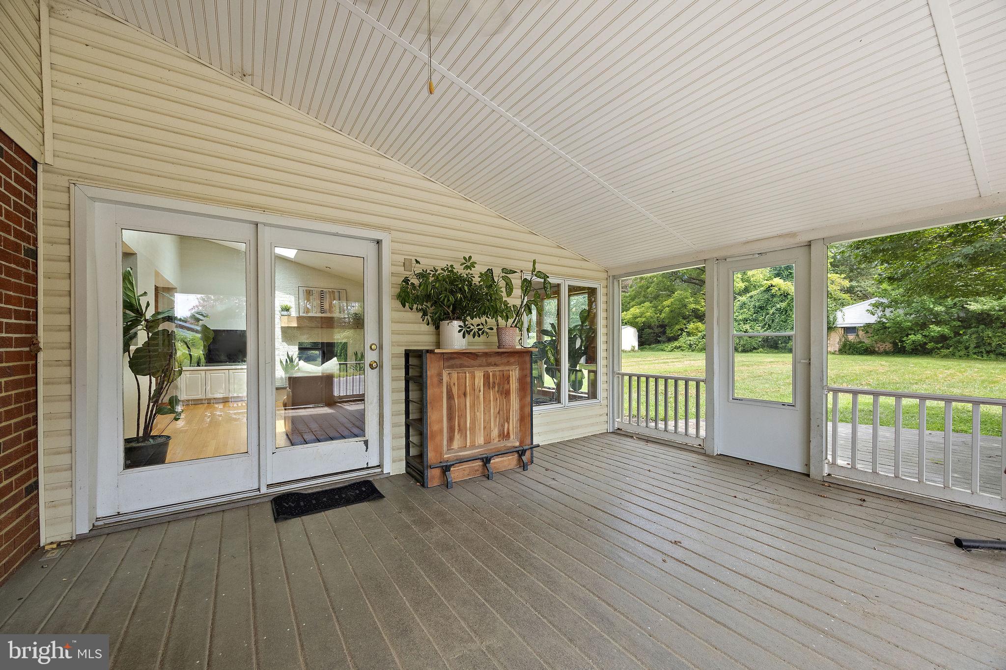 98 Husbands Drive Wilmington, DE 19803 - Photo 35 of 49 a view of a porch with wooden floor and floor to ceiling window