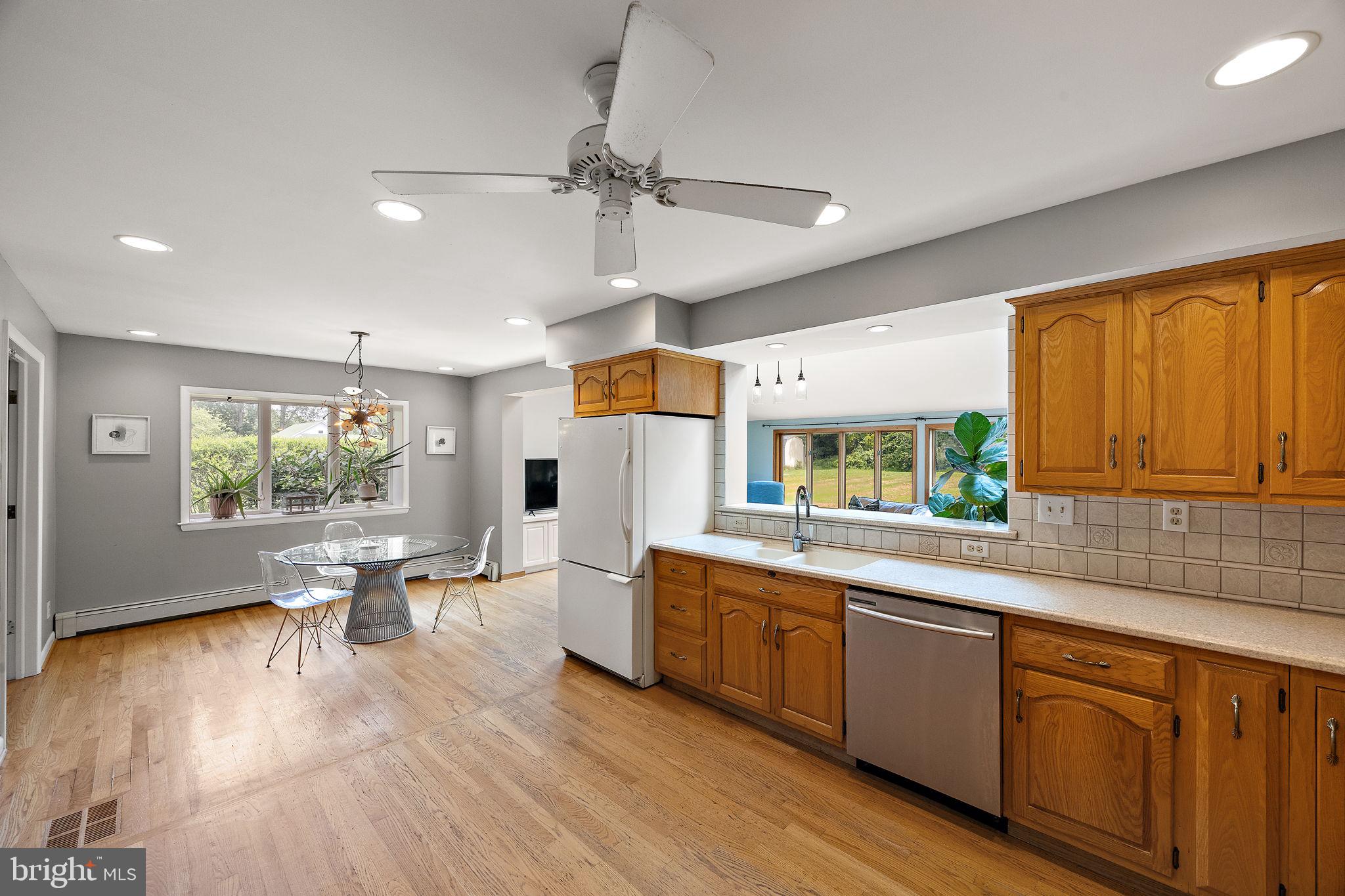 98 Husbands Drive Wilmington, DE 19803 - Photo 5 of 49 a open kitchen with stainless steel appliances granite countertop a stove top oven a chimney cabinets and wooden floor