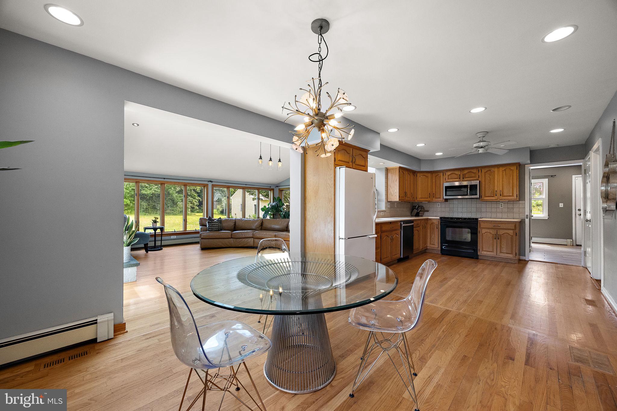 98 Husbands Drive Wilmington, DE 19803 - Photo 7 of 49 a kitchen with stainless steel appliances granite countertop a refrigerator dining table and chairs with wooden floor