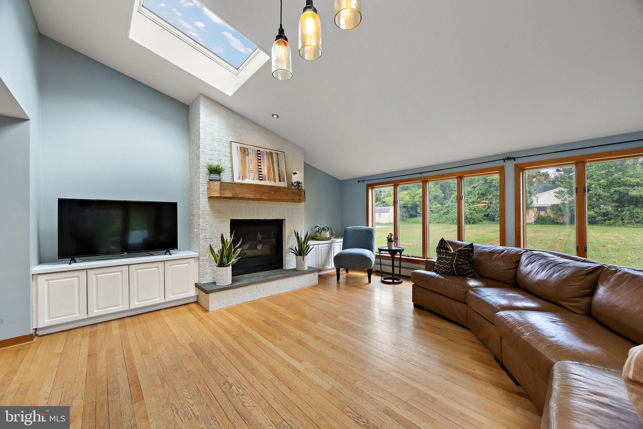 98 Husbands Drive Wilmington, DE 19803 - Photo 10 of 49 a living room with furniture a flat screen tv and a fireplace