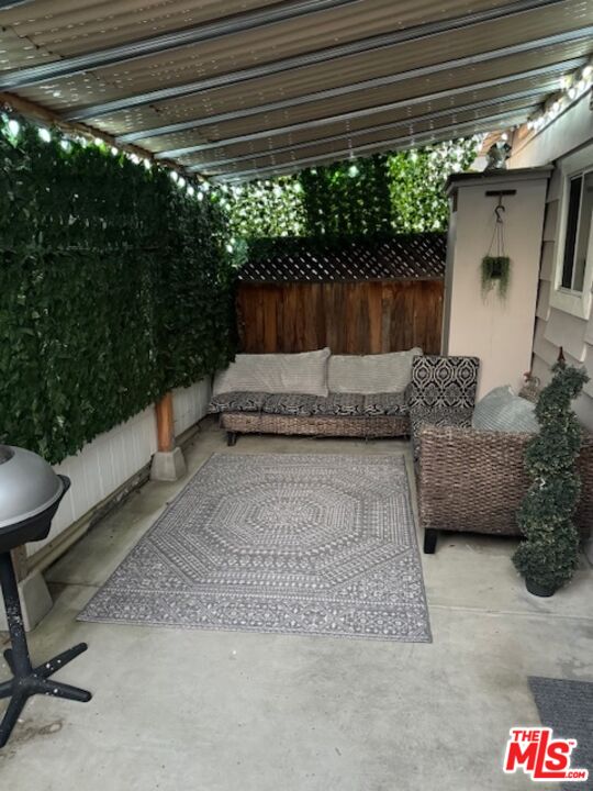 a building outdoor space with patio furniture and potted plants