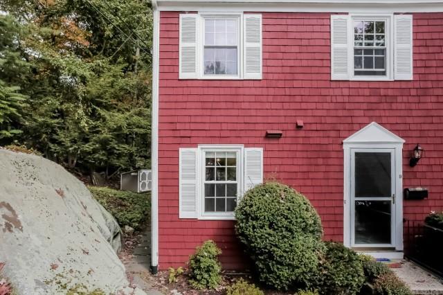 98 Valley Road, Unit 9 Greenwich, CT 06807 - Photo 1 of 1 a front view of a house with a garden
