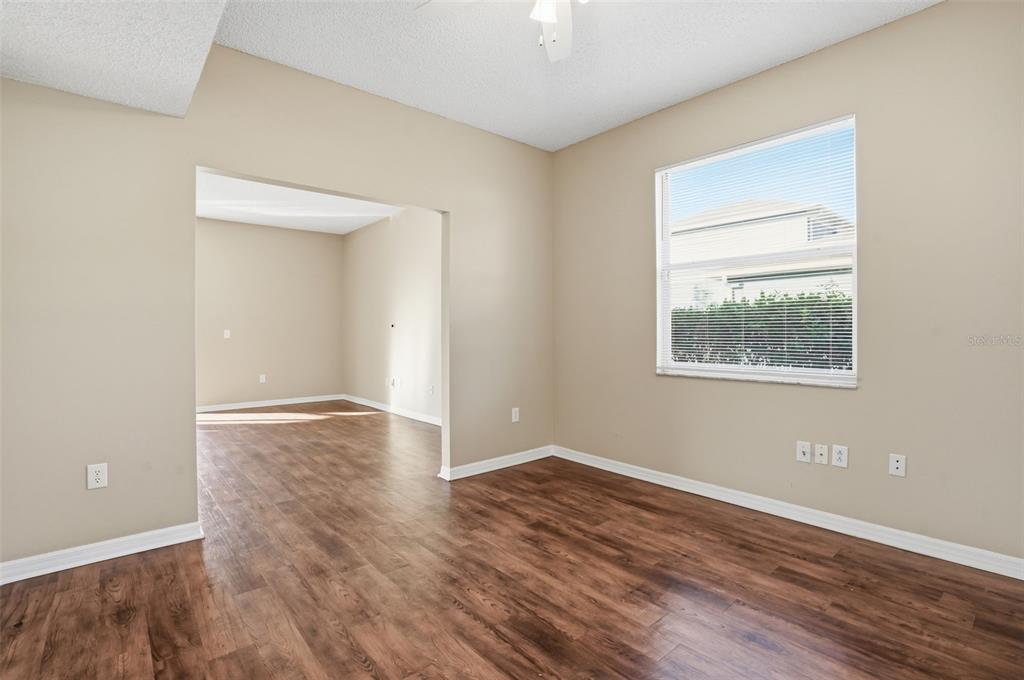 13032 St Filagree Drive Riverview, FL 33579 - Photo 13 of 44 an empty room with wooden floor and windows