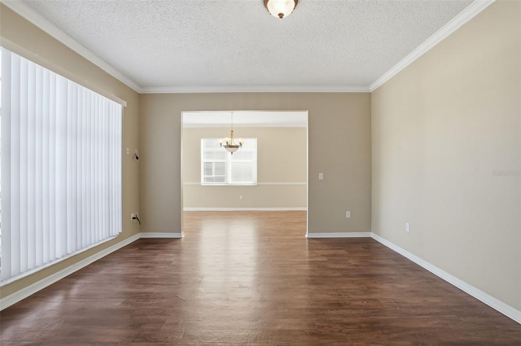 13032 St Filagree Drive Riverview, FL 33579 - Photo 14 of 44 a view of an empty room with wooden floor and a window