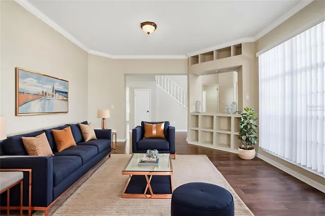 a living room with furniture and wooden floor