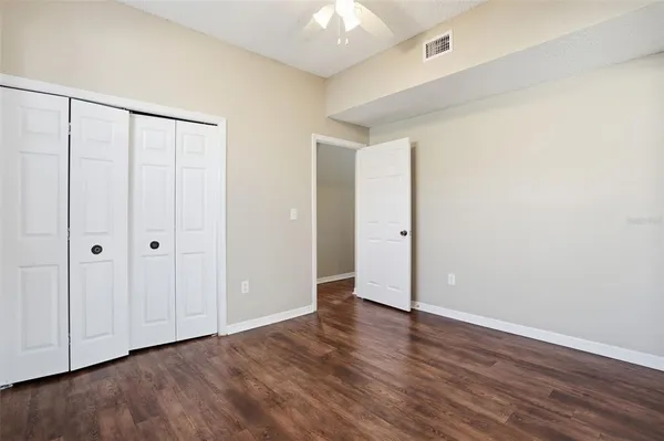 a view of an empty room with wooden floor