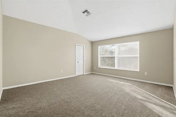 an empty room with a empty space and windows