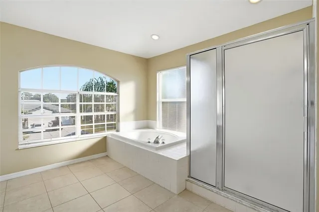 a bathroom with a tub shower and sink