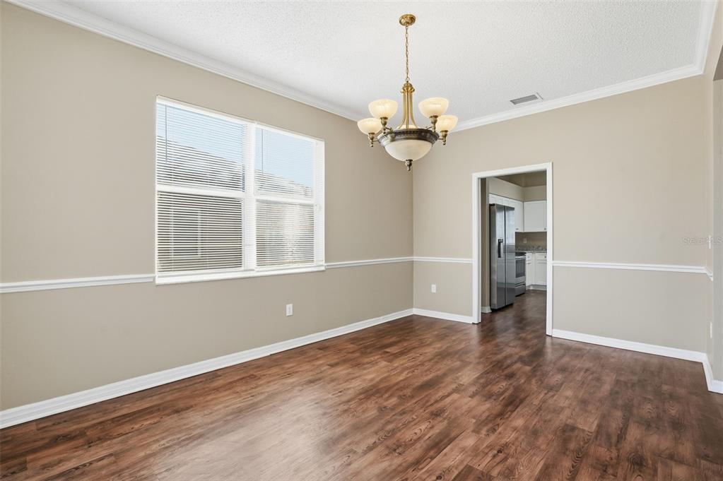 13032 St Filagree Drive Riverview, FL 33579 - Photo 5 of 44 a view of empty room with wooden floor and chandelier