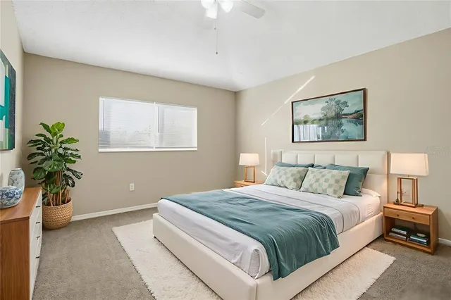 a bedroom with a bed and a potted plant