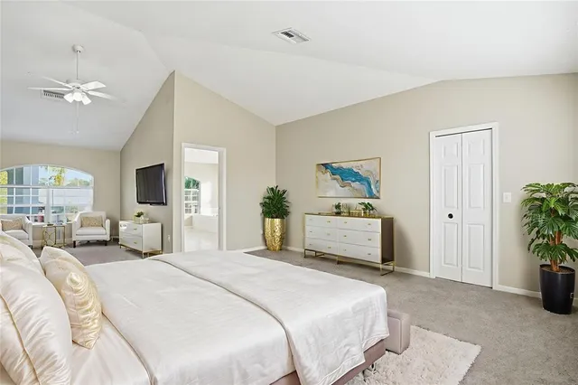 a bedroom with a bed and a couch