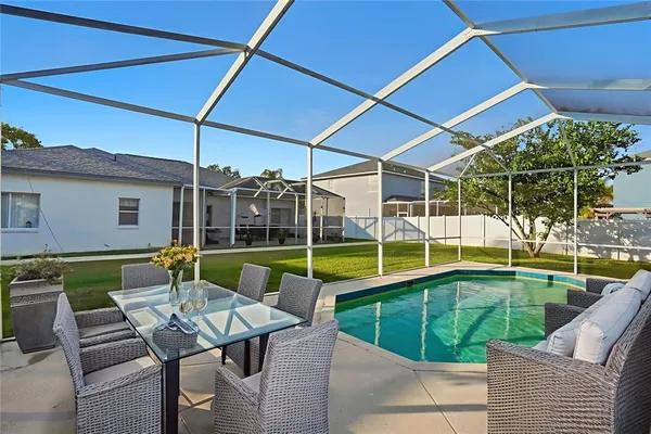a view of swimming pool with seating area and furniture