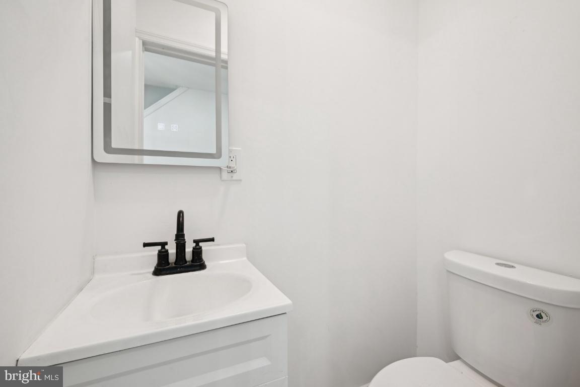718 Spruce Street Camden, NJ 08103 - Photo 11 of 39 a bathroom with a toilet sink and mirror
