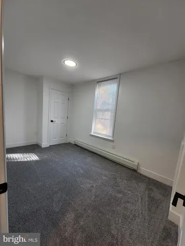 an empty room with a empty space and windows