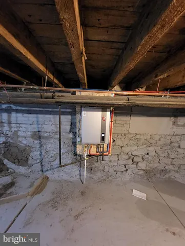 a kitchen with granite countertop a stove a sink a refrigerator and white cabinets