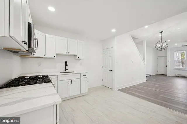 a kitchen with stainless steel appliances granite countertop a refrigerator sink and stove