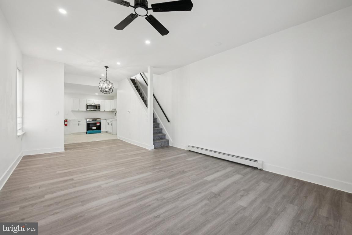 718 Spruce Street Camden, NJ 08103 - Photo 25 of 39 a view of a livingroom with wooden floor and stairs
