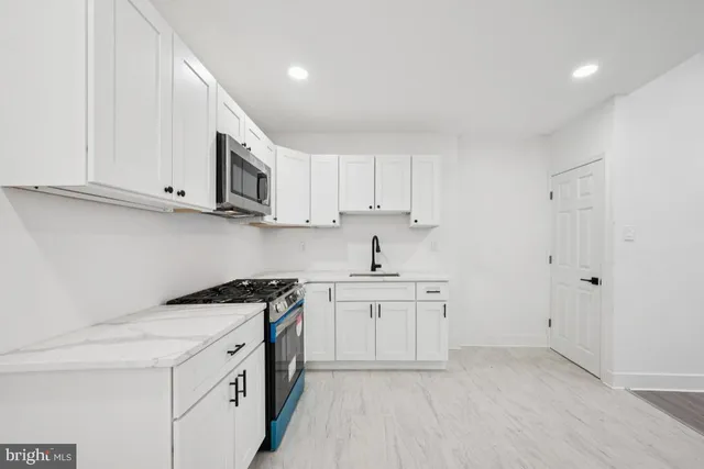 a white toilet sitting next to a bathroom sink