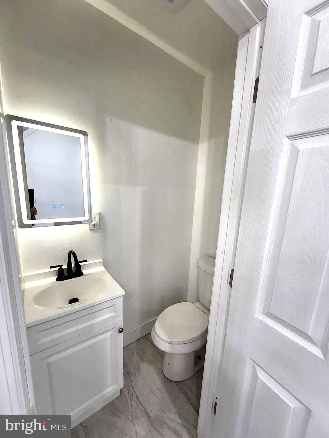 718 Spruce Street Camden, NJ 08103 - Photo 29 of 39 a bathroom with a sink a toilet and a mirror