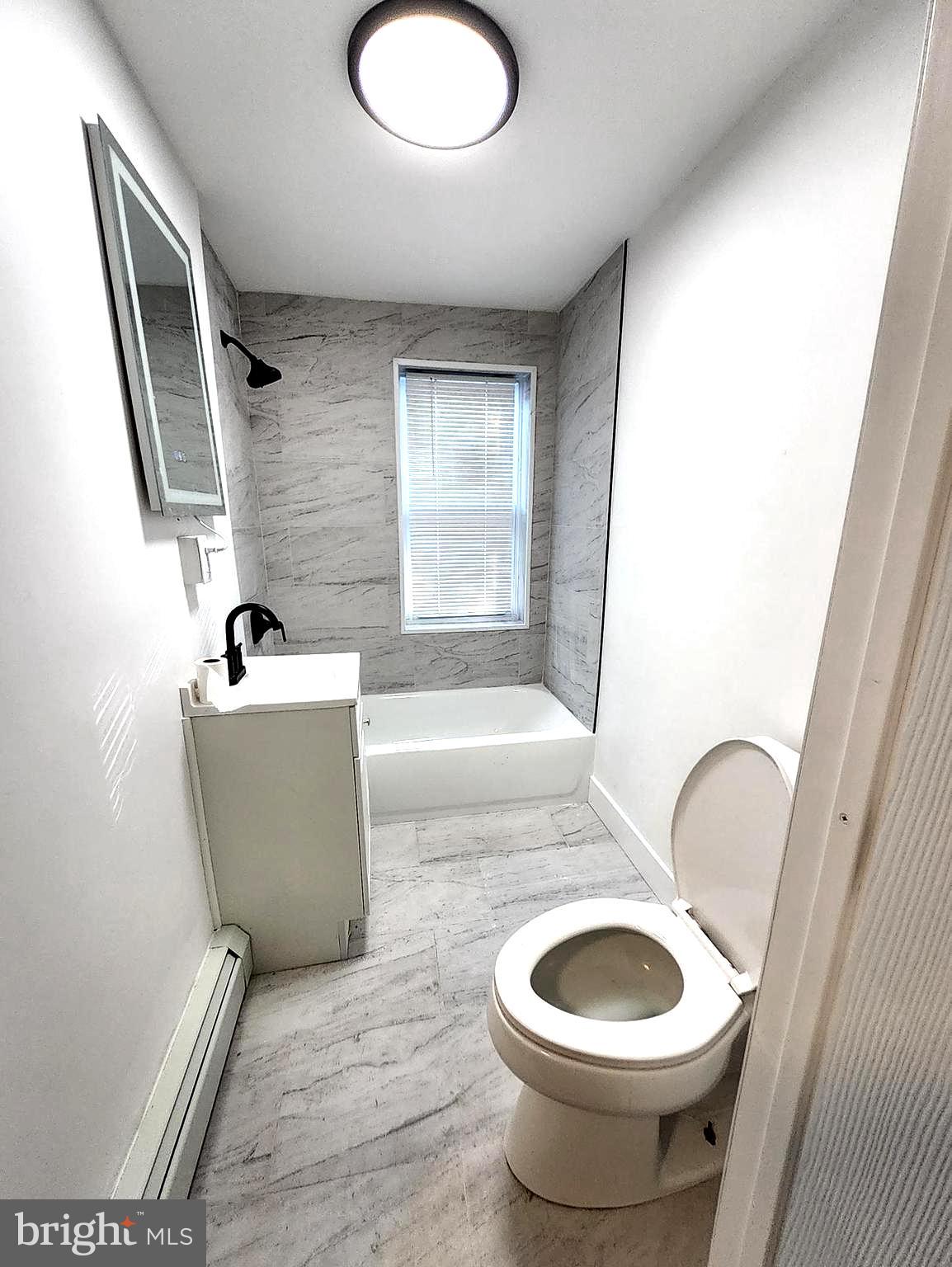 718 Spruce Street Camden, NJ 08103 - Photo 39 of 39 a bathroom with a toilet a sink and mirror