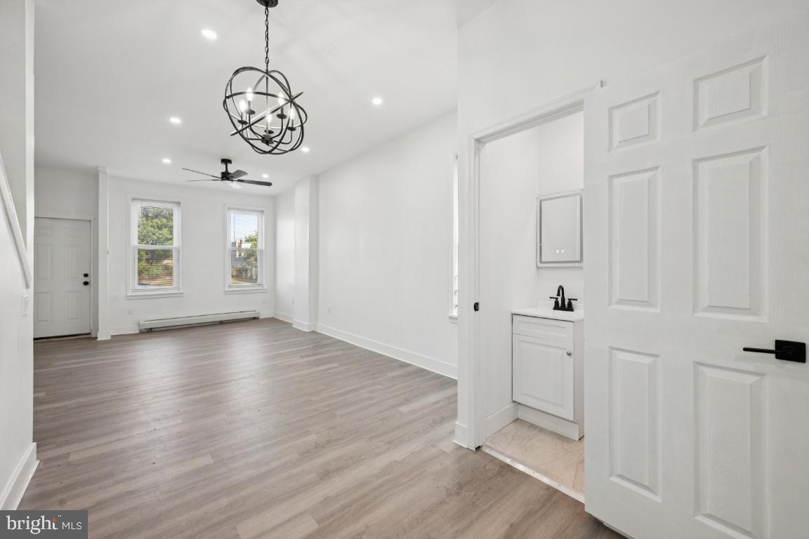 718 Spruce Street Camden, NJ 08103 - Photo 6 of 39 an empty room with wooden floor and windows