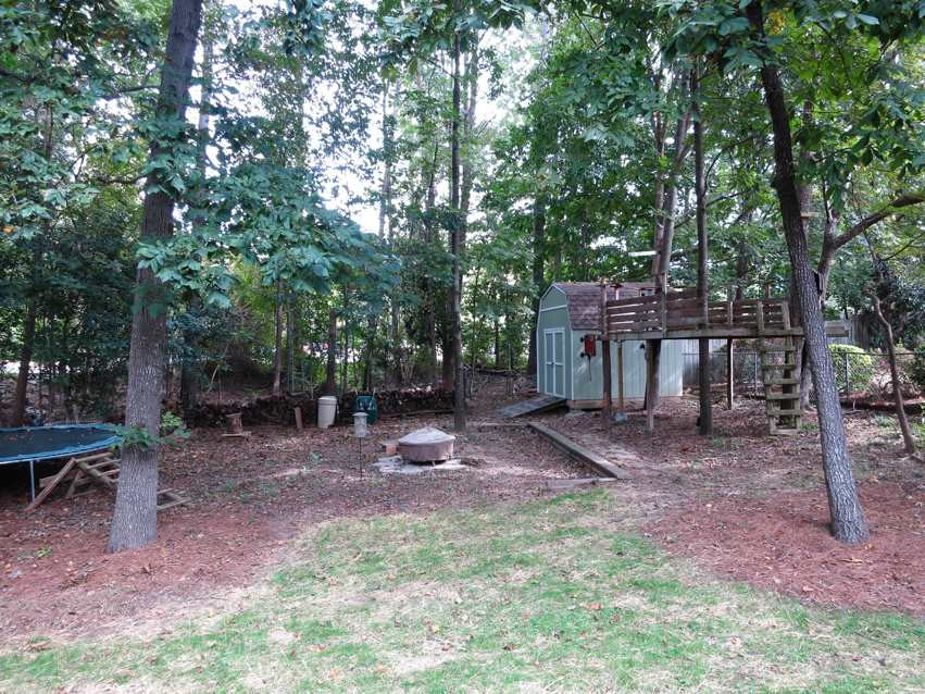 4516 Wingate Drive Raleigh, NC 27609 - Photo 24 of 25 Another view of the spacious, wooded backyard shows the Storage Shed & tree house. Backyard