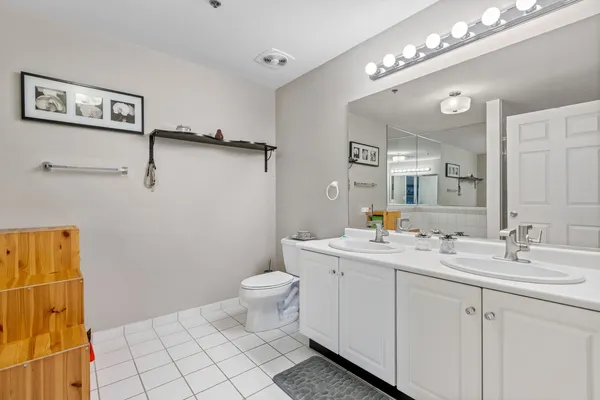 a bathroom with a sink mirror and toilet