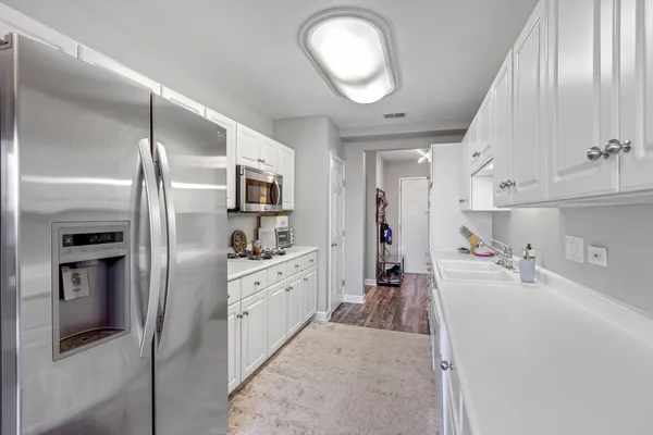 a kitchen with stainless steel appliances granite countertop a refrigerator and a sink