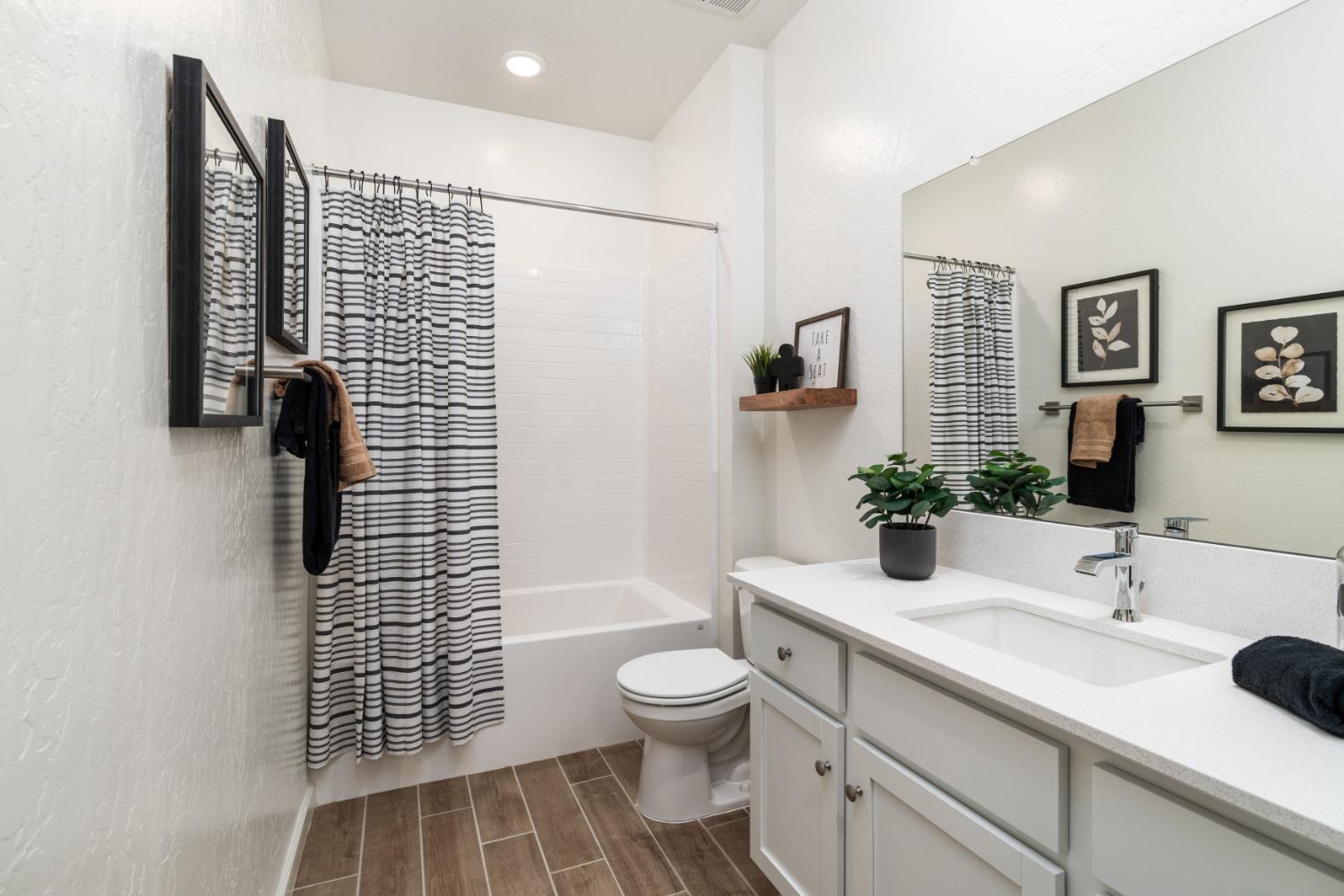 1150 Encore Way West Madera, CA 93636 - Photo 23 of 33 a bathroom with a granite countertop sink toilet and shower