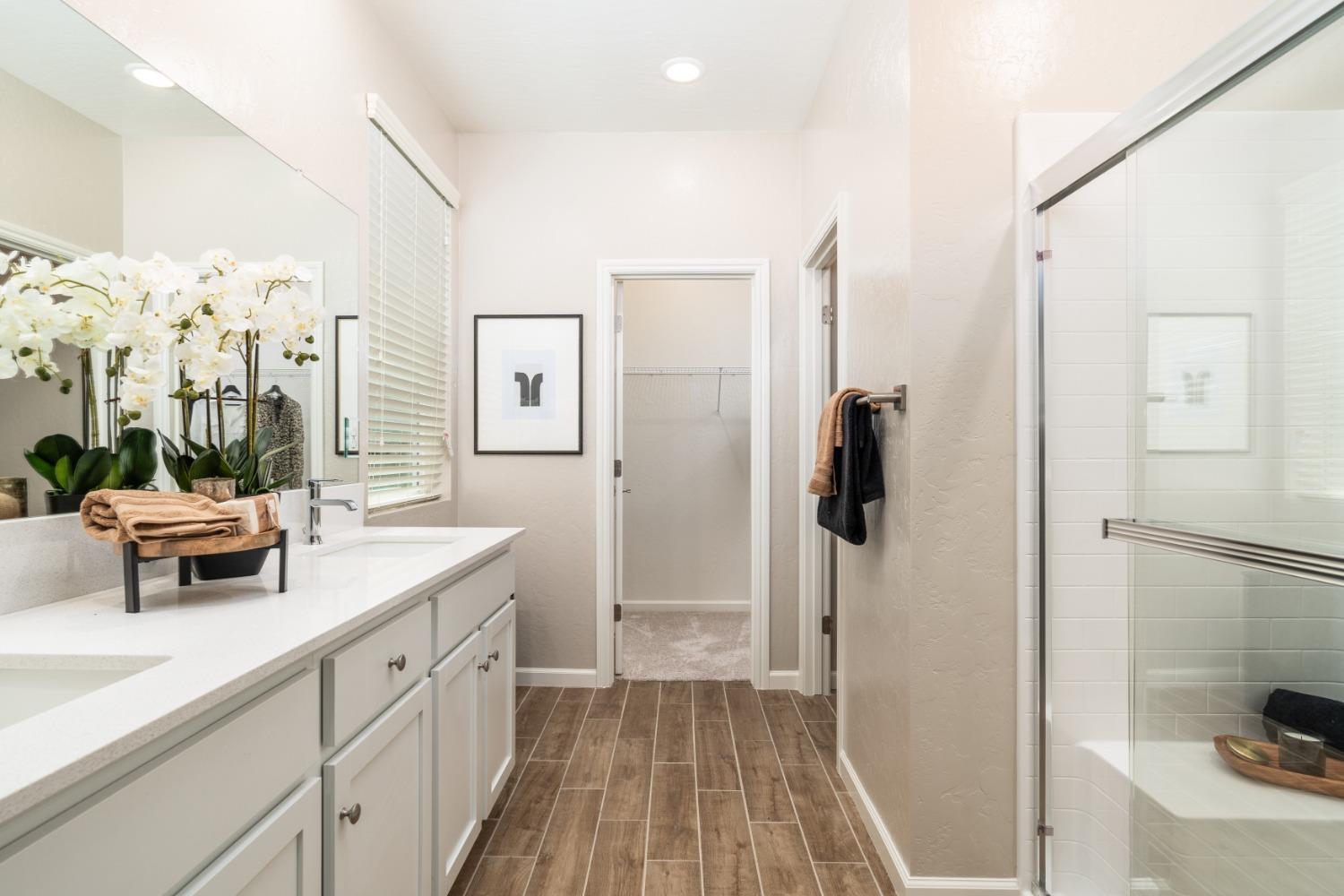 1150 Encore Way West Madera, CA 93636 - Photo 26 of 33 a spacious bathroom with a double vanity sink a mirror a shower and vanity