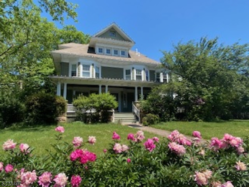 a front view of house with yard and flowers