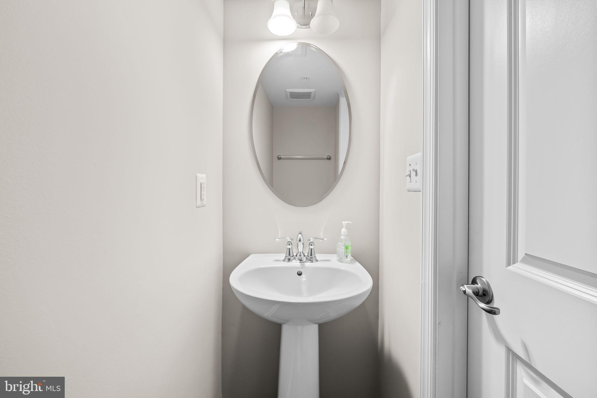 8206 Kirk Farm Circle Windsor Mill, MD 21244 - Photo 20 of 35 a bathroom with a sink and a mirror