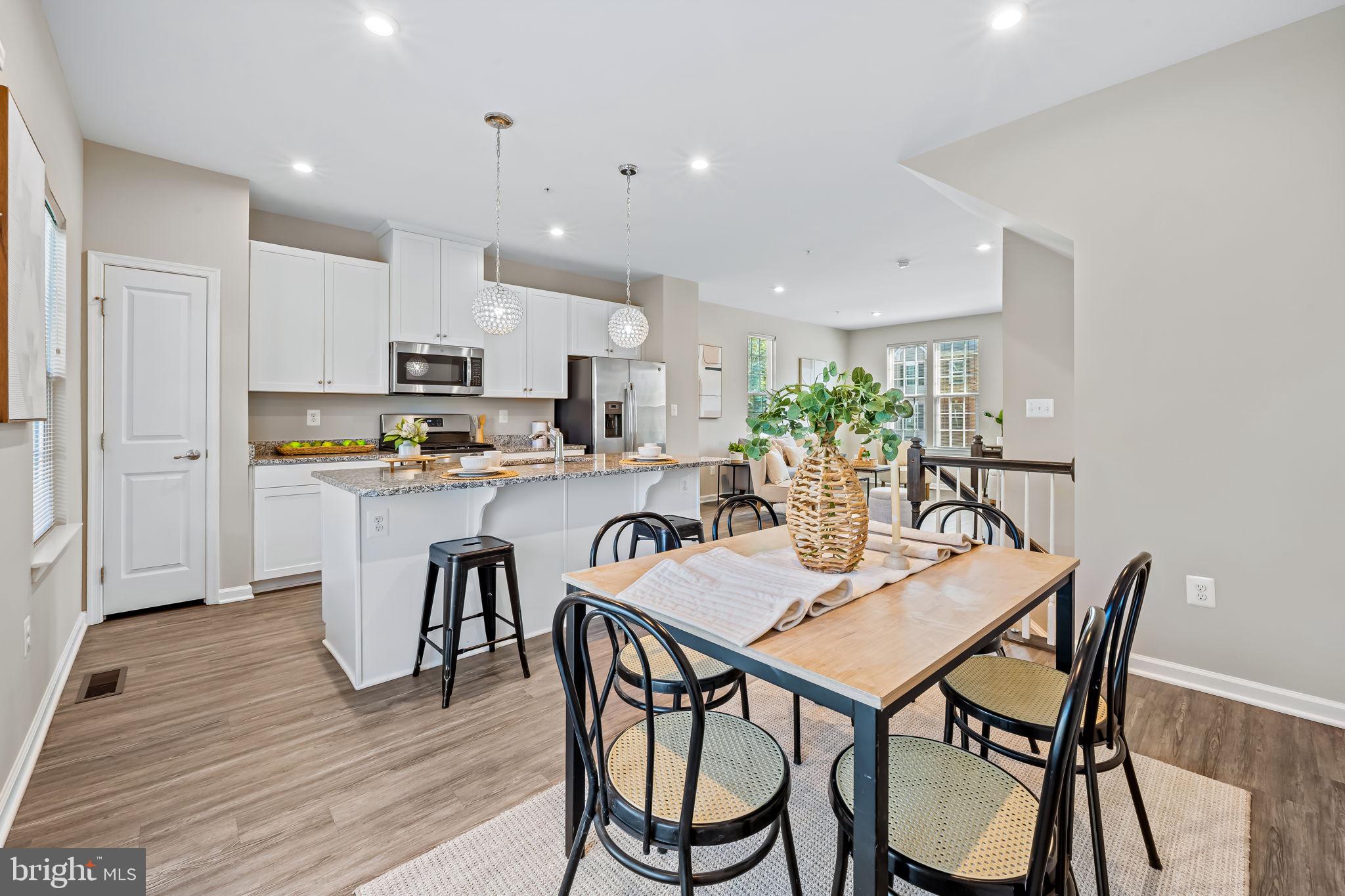 8206 Kirk Farm Circle Windsor Mill, MD 21244 - Photo 6 of 35 a dining room with kitchen island a table and chairs