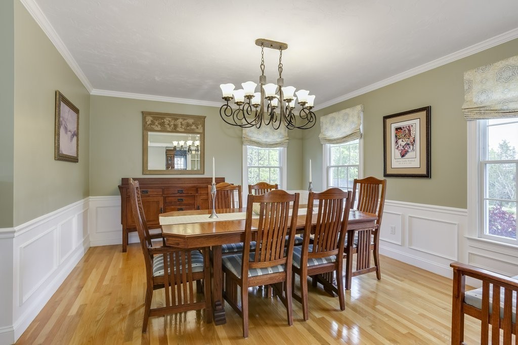 18 Spring Valley Road Hull, MA 02045 - Photo 10 of 30 a view of a dining room with furniture a chandelier and wooden floor