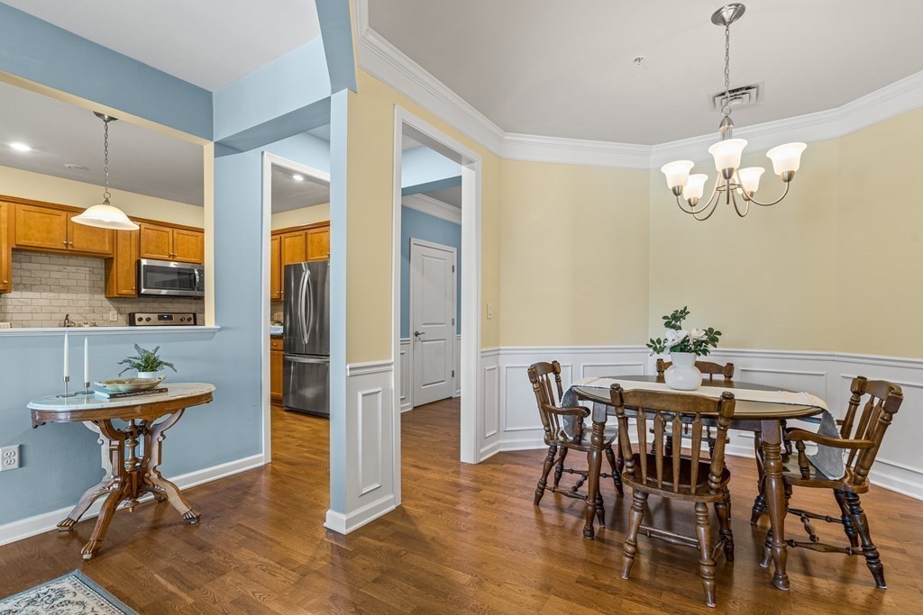 36 Abigail Way, Unit 3009 Reading, MA 01867 - Photo 15 of 36 a view of a dining room with furniture a chandelier and wooden floor
