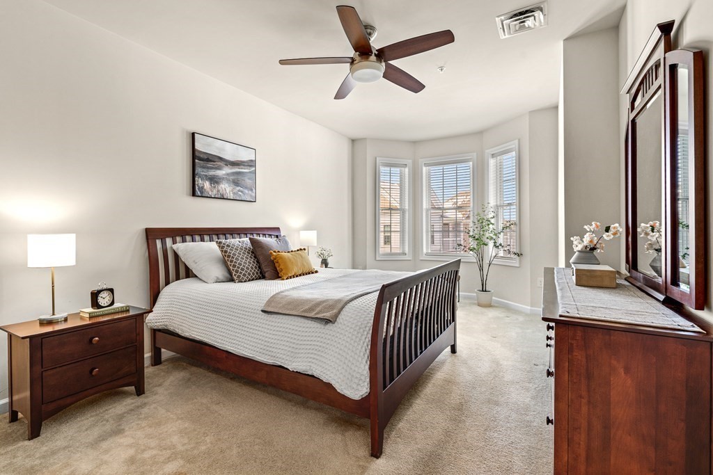 36 Abigail Way, Unit 3009 Reading, MA 01867 - Photo 17 of 36 a spacious bedroom with a bed and a chandelier