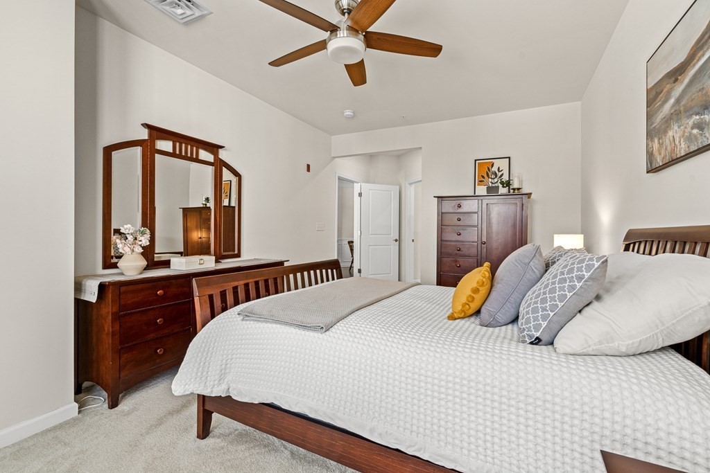 36 Abigail Way, Unit 3009 Reading, MA 01867 - Photo 19 of 36 a bedroom with a large bed and a chandelier